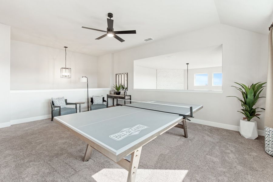 Game room with ping pong table, ceiling fan, carpet flooring, and seating area Game room with ping pong table, ceiling fan, carpet flooring, and seating area