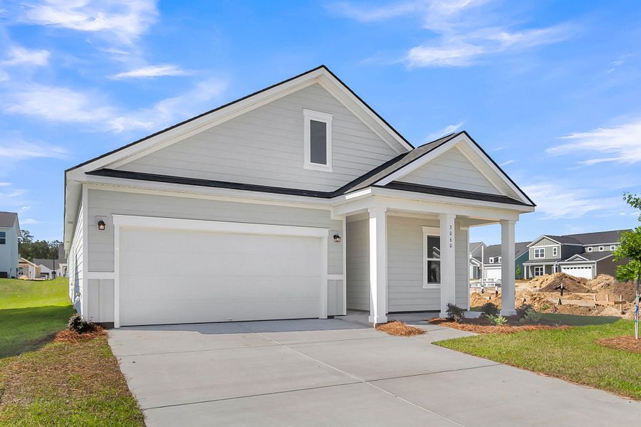 Front exterior of a new home in Tea Farm, Ravenel, SC, highlighting curb appeal (Image 18).