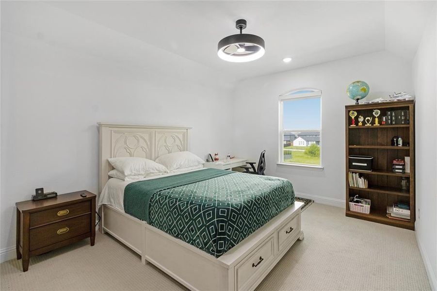 Carpeted room featuring a double window, vaulted ceiling, recessed lighting, and a contemporary ceiling fan