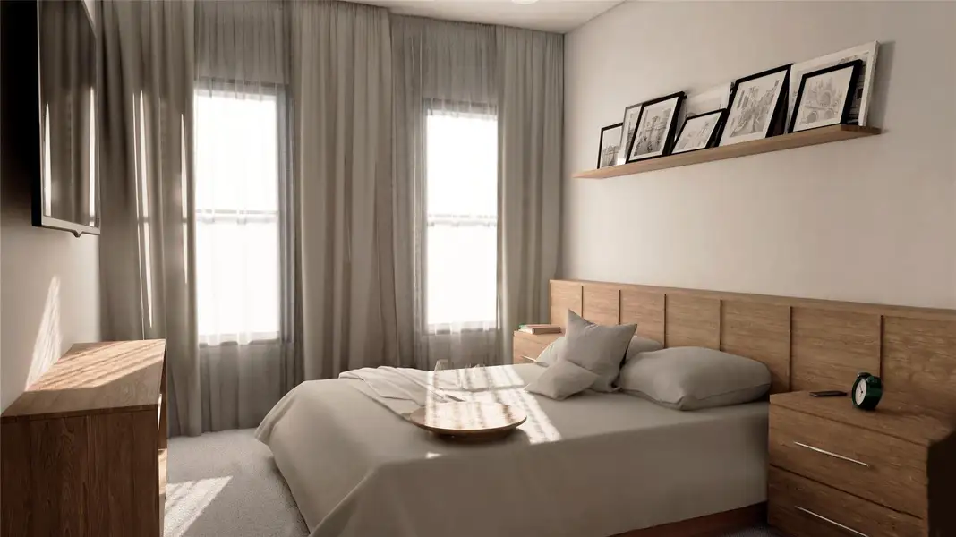 Carpeted bedroom featuring multiple windows Carpeted bedroom featuring multiple windows