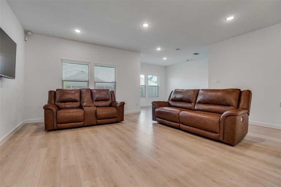 Living area featuring light wood-type flooring and recessed lighting Living area featuring light wood-type flooring and recessed lighting