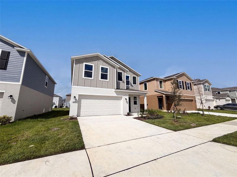 Front exterior of a new home in Ranches at Lake Mcleod, Eagle Lake, FL, highlighting curb appeal (Image 2).
