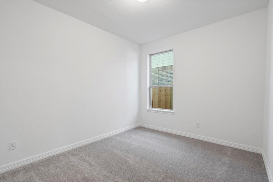 Your secondary bedroom features plush carpet, fresh paint, closet, and a large window that lets in plenty of natural lighting.