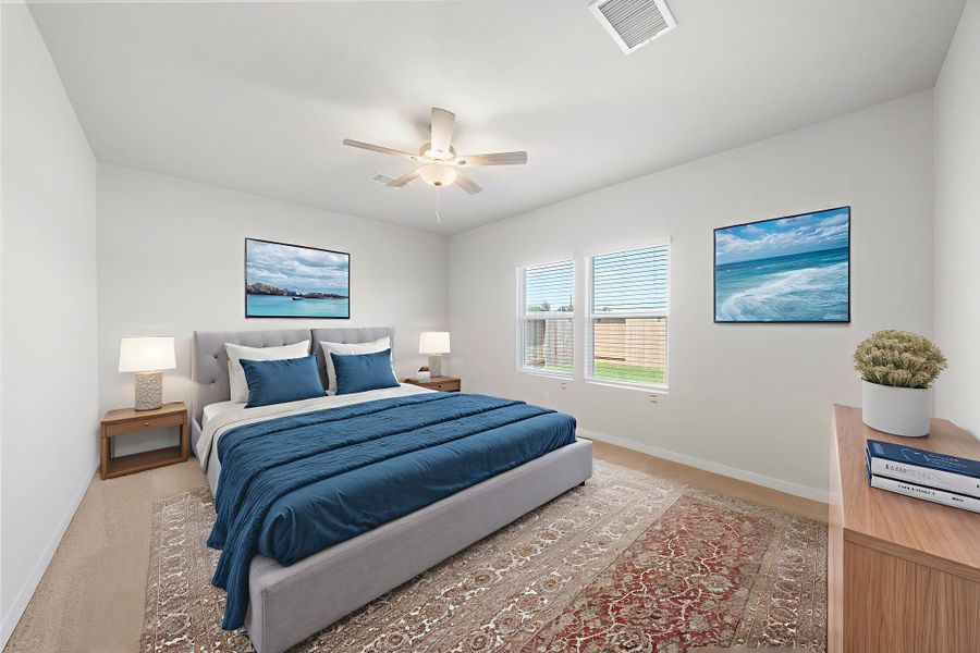 A bedroom with a bed and a fan.