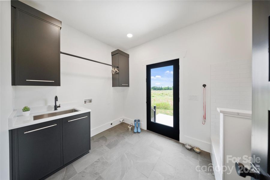 Laundry Room with Side Door Entrance, Natural Stone Floor, Quartz counter-top for folding laundry & stainless steel utility sink Laundry Room with Side Door Entrance, Natural Stone Floor, Quartz counter-top for folding laundry & stainless steel utility sink