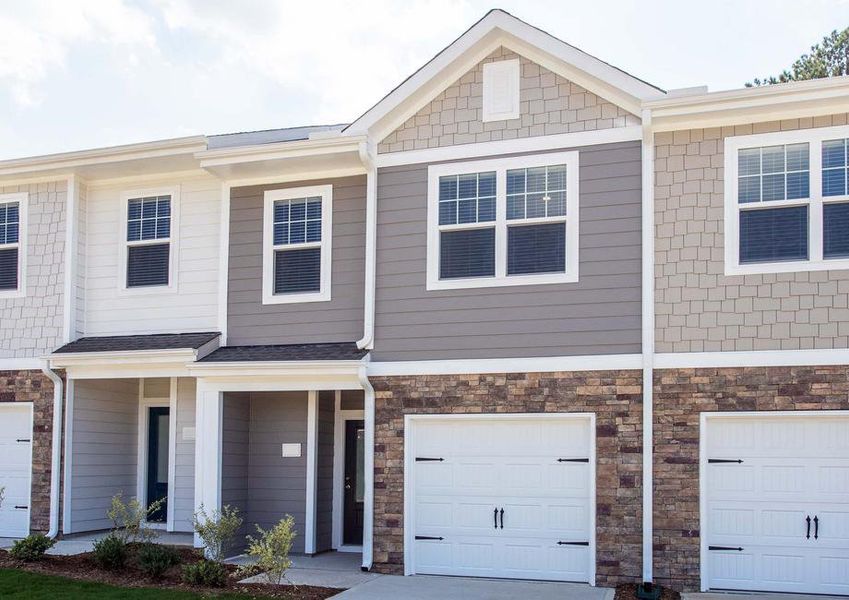 The two-story Bradford A elevation with an attached garage and stone accent detailing.