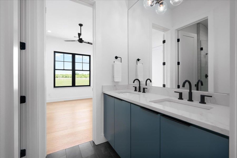 Full bathroom with a ceiling fan, double vanity, and an enclosed shower
