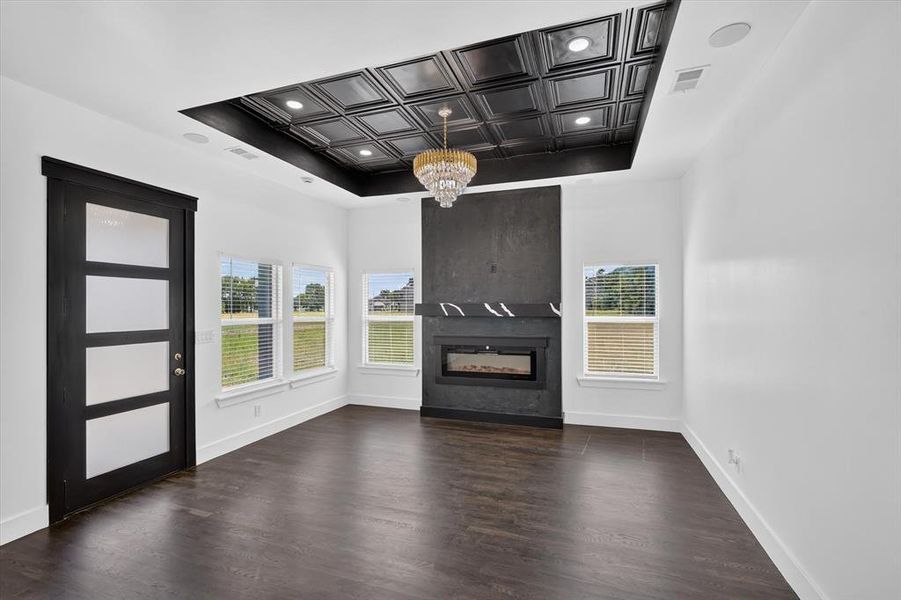Open-concept room featuring dark wood-finish flooring and multiple windows