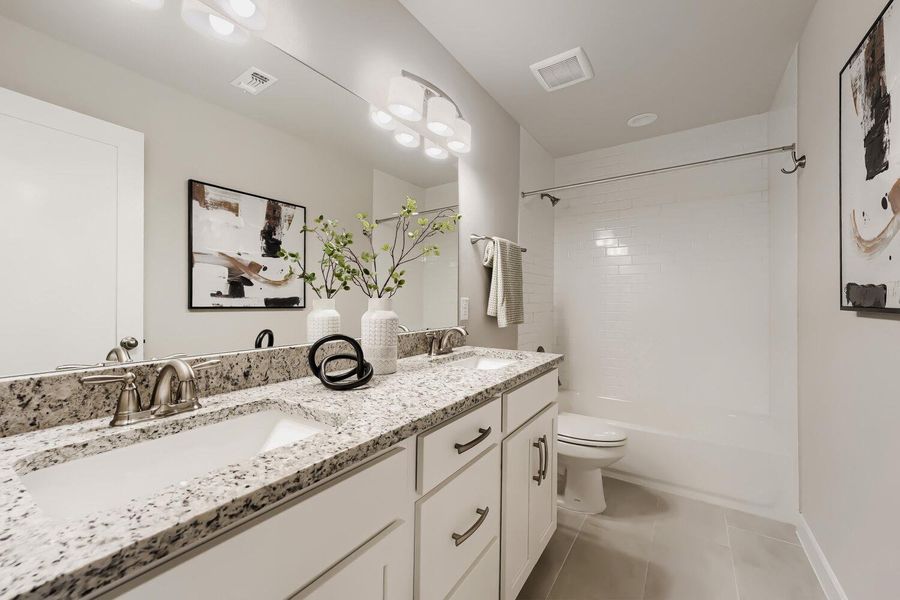 Granite counters and dual sinks define this elegant, well-appointed primary bathroom. Granite counters and dual sinks define this elegant, well-appointed primary bathroom.