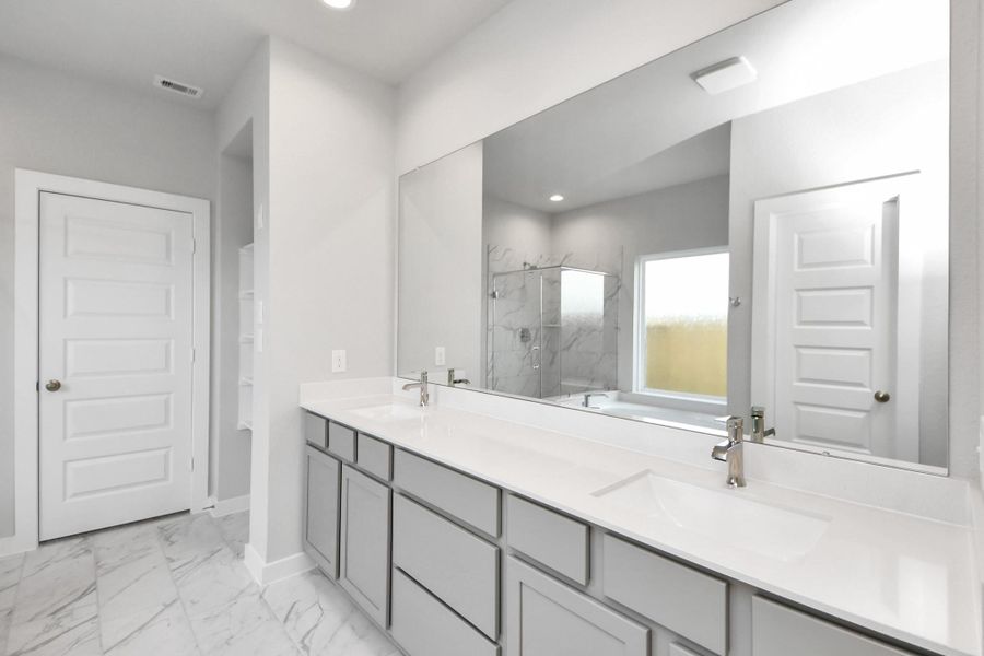 Elevate your daily routine at the refined vanity, now boasting double sinks, light-toned countertops, modern hardware, and captivating recessed lights. Elevate your daily routine at the refined vanity, now boasting double sinks, light-toned countertops, modern hardware, and captivating recessed lights.