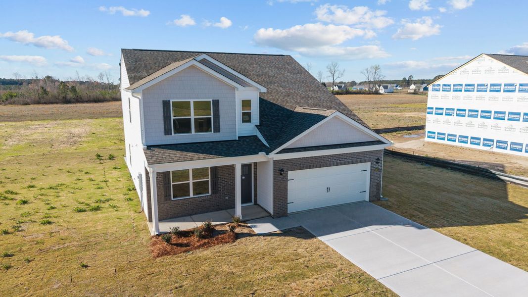 Front exterior of a new home in Beaver Dam Crossing, Bailey, NC, highlighting curb appeal (Image 20). Front exterior of a new home in Beaver Dam Crossing, Bailey, NC, highlighting curb appeal (Image 20).