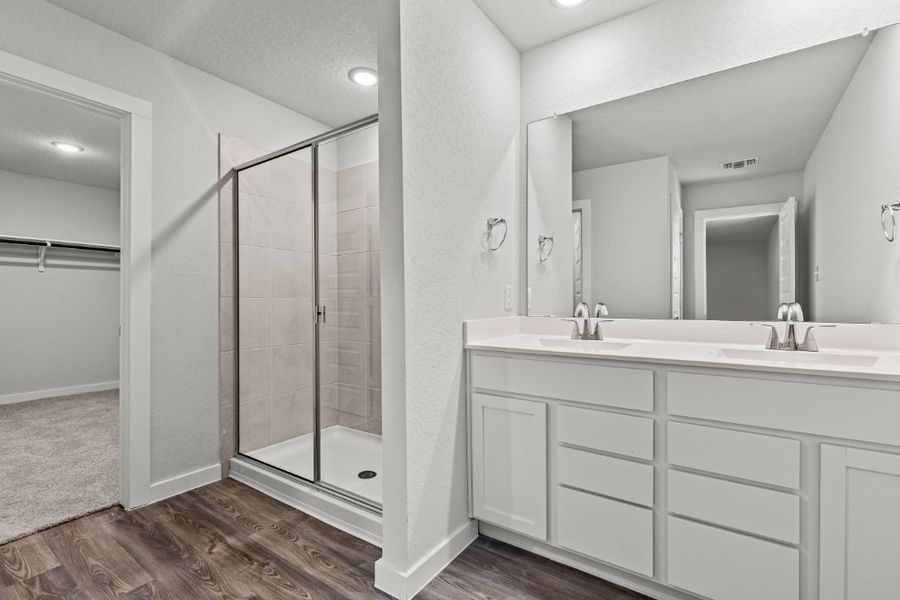 A bathroom with a glass shower. A bathroom with a glass shower.