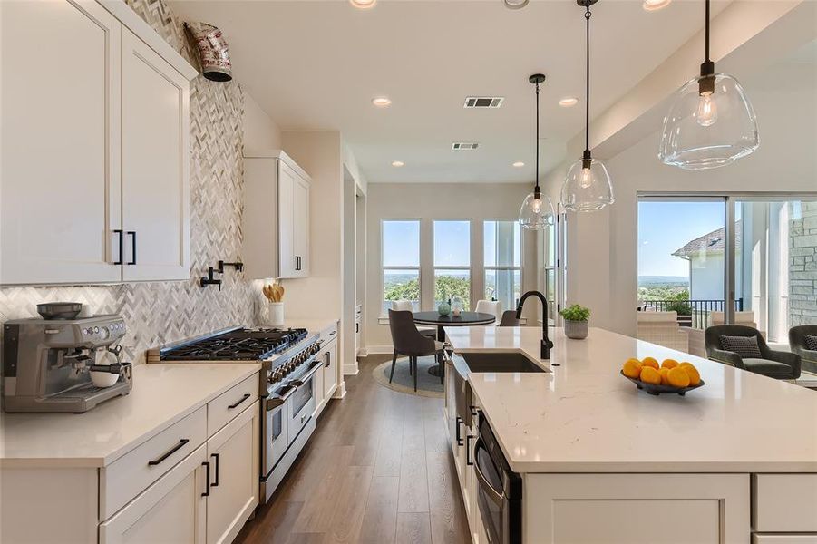 Gourmet kitchen with commercial grade cooktop with double ovens, microwave drawer, pot filler and spacious Quartz island. (virtual staging)