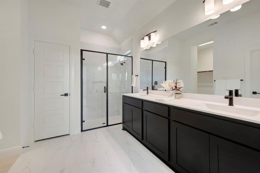 Full bath with double vanity, a marble finish shower, light marble finish flooring, and recessed lighting Full bath with double vanity, a marble finish shower, light marble finish flooring, and recessed lighting