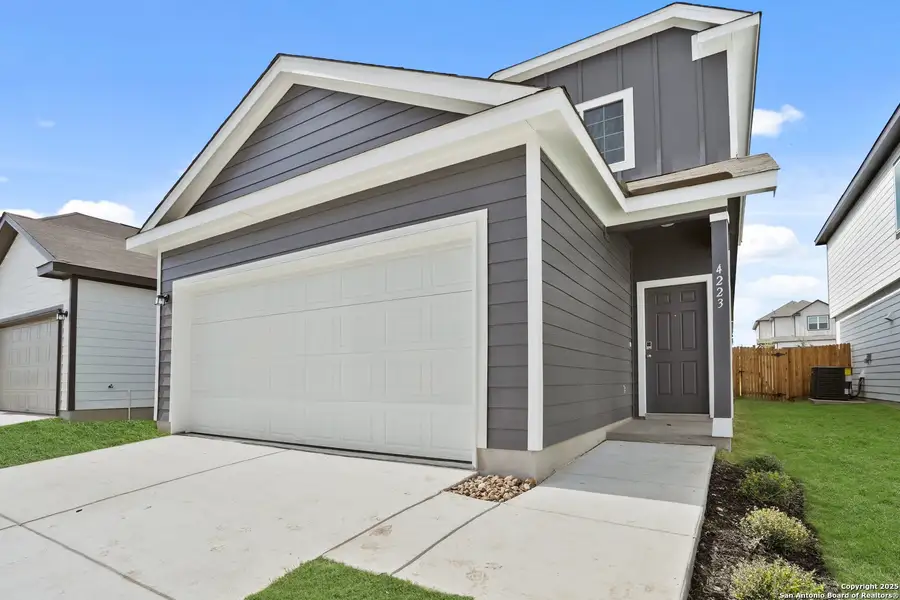 Front exterior of a new home in Melissa Ranch, San Antonio, TX, highlighting curb appeal (Image 2). Front exterior of a new home in Melissa Ranch, San Antonio, TX, highlighting curb appeal (Image 2).