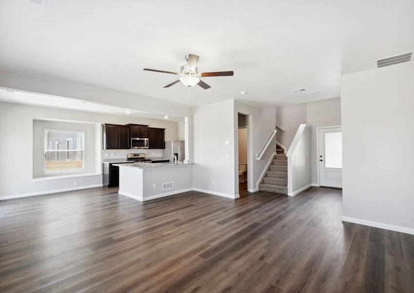 Open-concept layout of the living room, dining area, and kitchen.