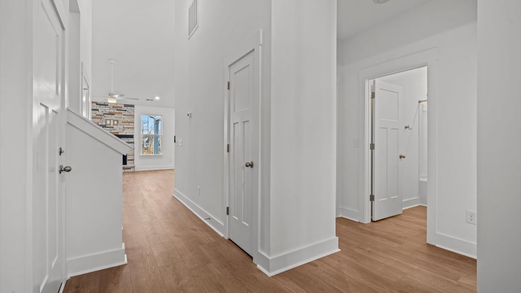 Superior design begins at the front door with a hardwood floor foyer and elegant sightlines