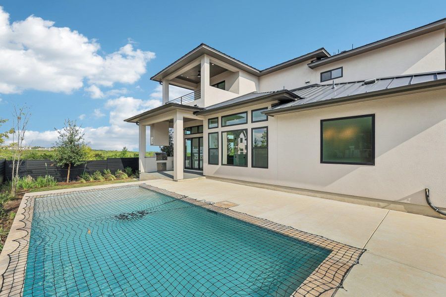 View of swimming pool with a balcony and a patio area