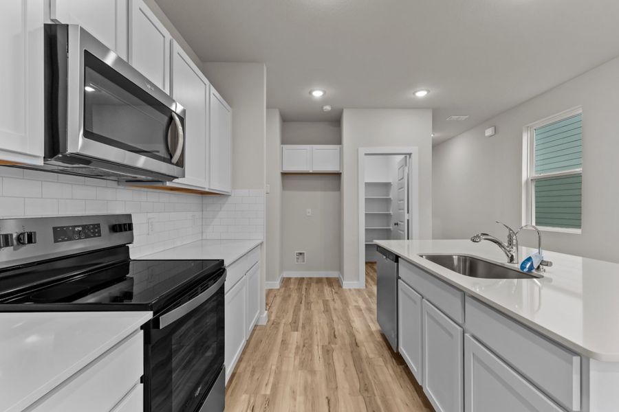 A kitchen with white cabinets. A kitchen with white cabinets.