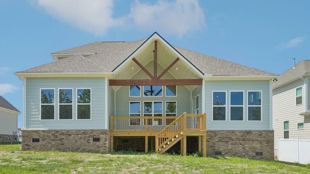 Rear exterior view of two-story home featuring back porch