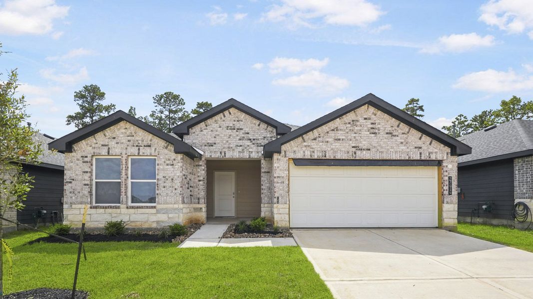 Front exterior of a new home in Grand Pines, Magnolia, TX, highlighting curb appeal (Image 1). Front exterior of a new home in Grand Pines, Magnolia, TX, highlighting curb appeal (Image 1).