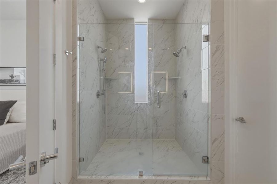 Full bath featuring connected bathroom and a marble finish shower