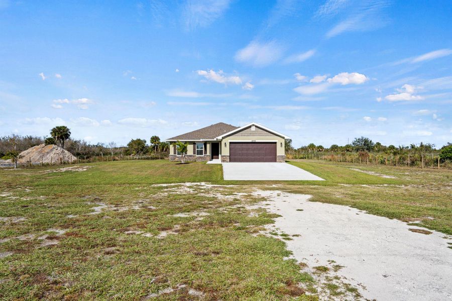 Front exterior of a new home in , Okeechobee, FL, highlighting curb appeal (Image 22).