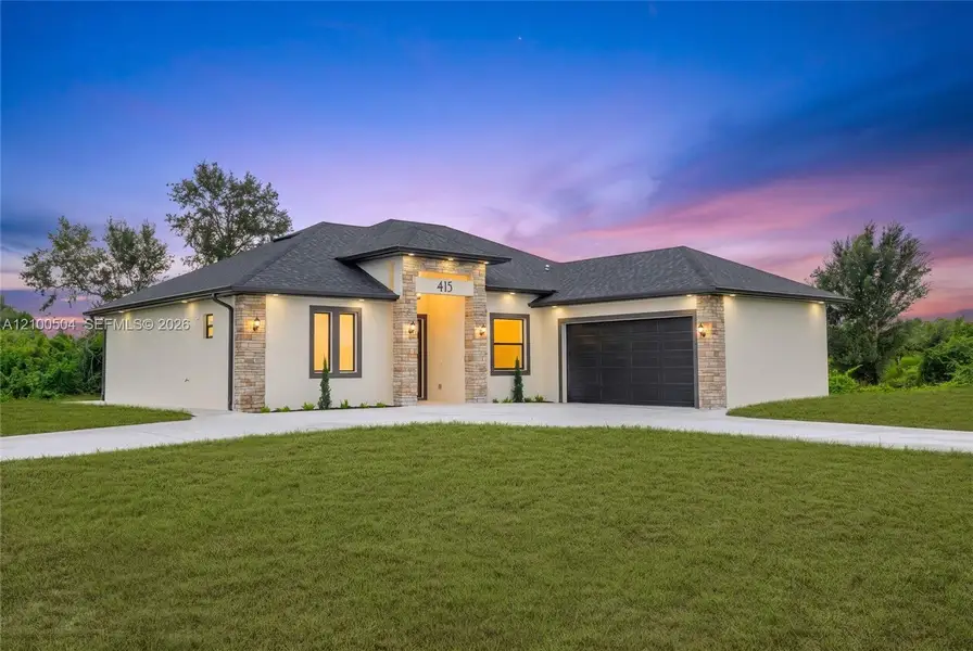 Front exterior of a new home in , Lehigh Acres, FL, highlighting curb appeal (Image 24). Front exterior of a new home in , Lehigh Acres, FL, highlighting curb appeal (Image 24).