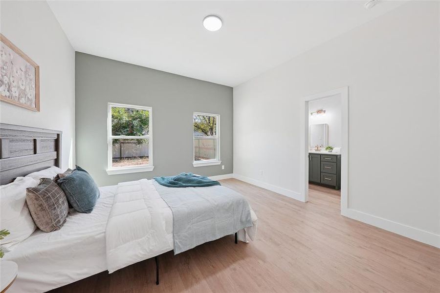Bedroom with light wood-type flooring and baseboards