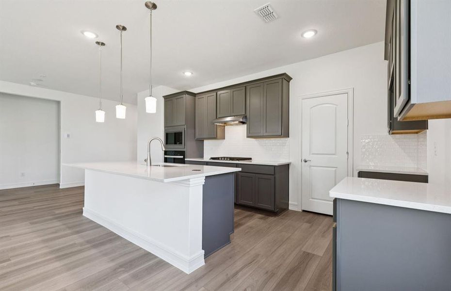Spacious kitchen with pendant lighting