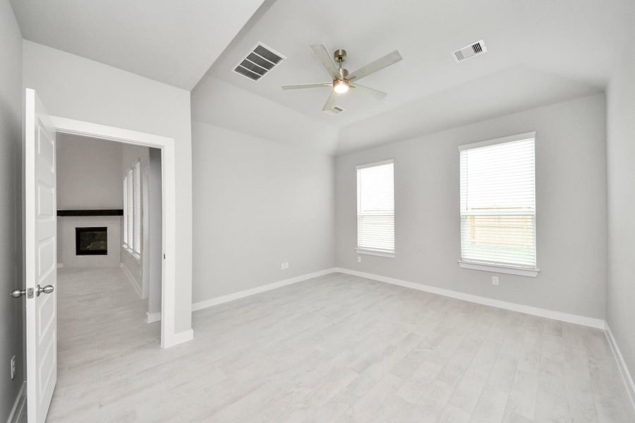 Come and unwind after a long day in this magnificent primary suite! This spacious room features beautiful flooring, warm paint, high ceilings and large windows with privacy blinds. Sample photo of completed home with similar floor plan. Actual colors and selections may vary. Come and unwind after a long day in this magnificent primary suite! This spacious room features beautiful flooring, warm paint, high ceilings and large windows with privacy blinds. Sample photo of completed home with similar floor plan. Actual colors and selections may vary.
