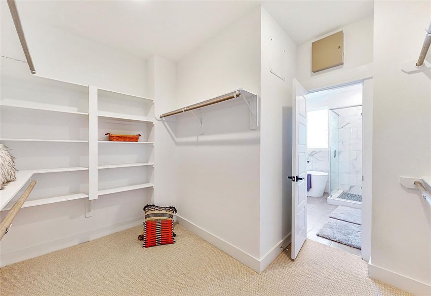This well-proportioned primary closet offers a practical blend of space and organization, ideal for everyday use. With ample room for hanging garments and shelving for folded items or accessories, it balances functionality with comfort.