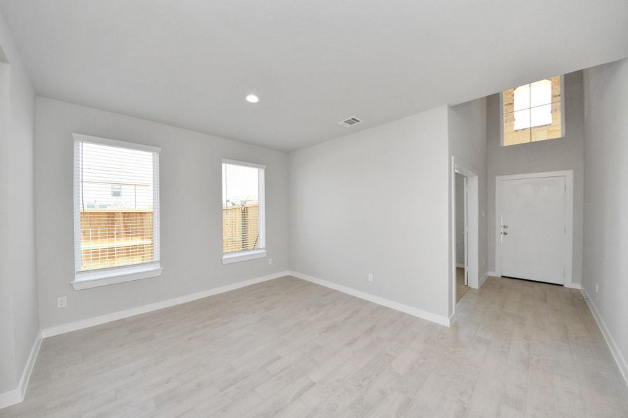 Create lasting memories with your family and friends at the dining table! This expansive dining room showcases sophisticated flooring, custom paint, and seamlessly connects to the family room and kitchen, providing an open and inviting atmosphere. Sample photo of completed home with similar floor plan. Actual colors and selections may vary. Create lasting memories with your family and friends at the dining table! This expansive dining room showcases sophisticated flooring, custom paint, and seamlessly connects to the family room and kitchen, providing an open and inviting atmosphere. Sample photo of completed home with similar floor plan. Actual colors and selections may vary.