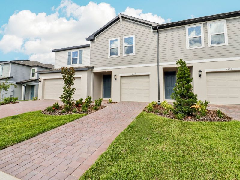 Front exterior of a new home in Cagan Crossings West, Clermont, FL, highlighting curb appeal (Image 1). Front exterior of a new home in Cagan Crossings West, Clermont, FL, highlighting curb appeal (Image 1).