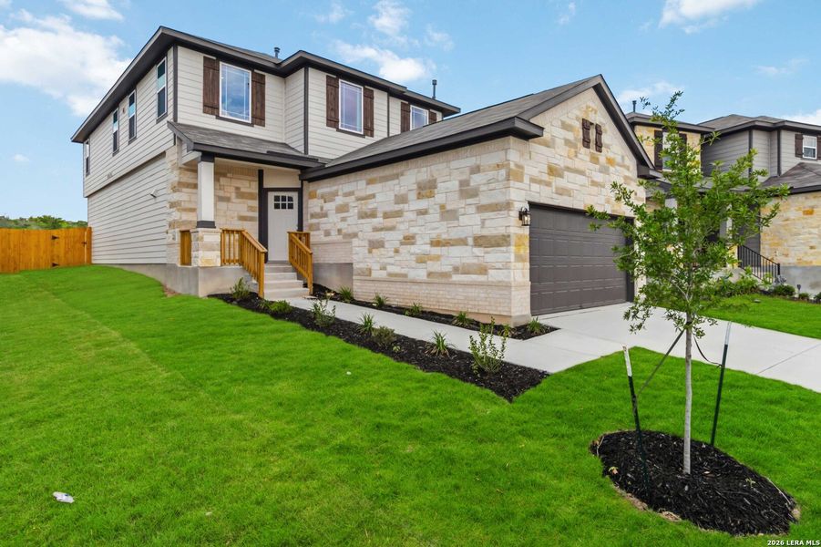 Front exterior of a new home in Hunters Ranch, San Antonio, TX, highlighting curb appeal (Image 2). Front exterior of a new home in Hunters Ranch, San Antonio, TX, highlighting curb appeal (Image 2).