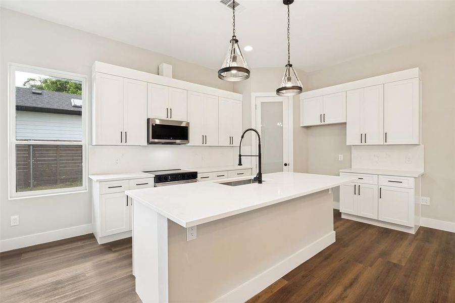 Contemporary kitchen with white shaker cabinetry and a central island