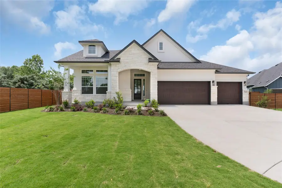 View of front of property with stone siding, a garage, concrete driveway, and roof with shingles View of front of property with stone siding, a garage, concrete driveway, and roof with shingles