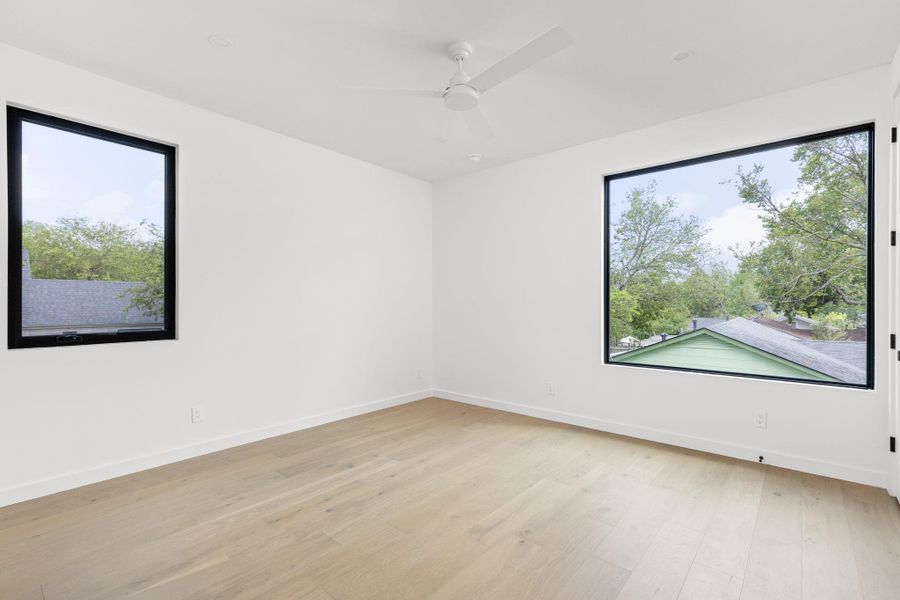 Unfurnished room featuring light wood-type flooring and ceiling fan
