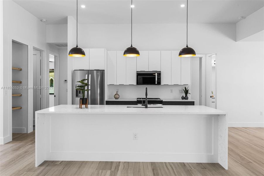MODERN KITCHEN w/ SS appliances, including refrigerator/freezer, microwave, range & dishwasher. MODERN KITCHEN w/ SS appliances, including refrigerator/freezer, microwave, range & dishwasher.