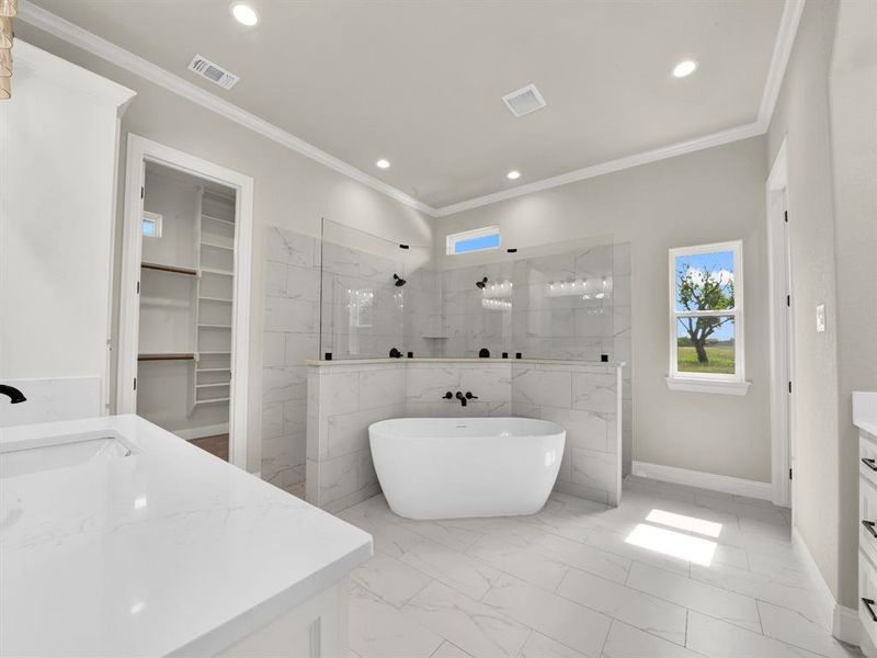 Bathroom with marble look tile flooring, walk in shower, vanity, recessed lighting, and crown molding Bathroom with marble look tile flooring, walk in shower, vanity, recessed lighting, and crown molding