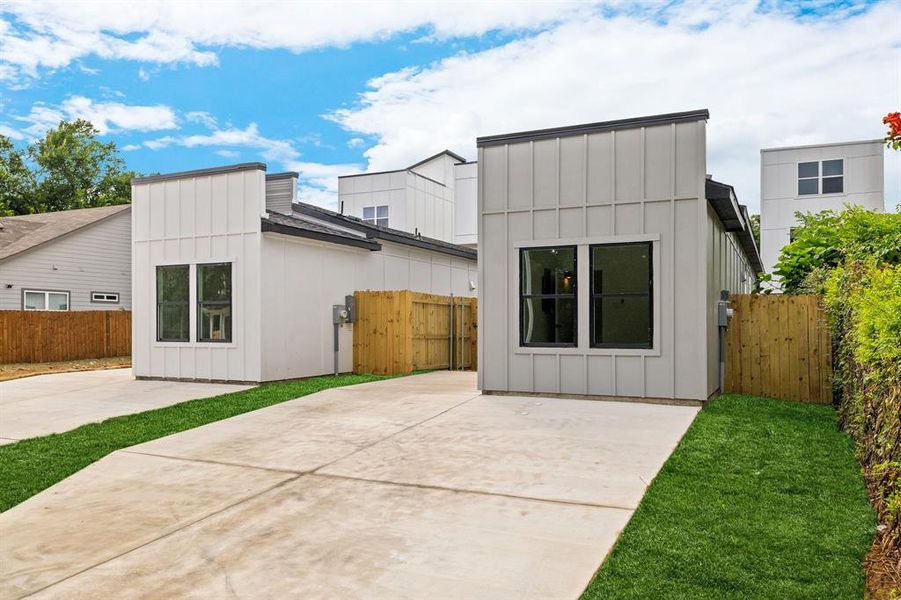 Rear view of property with board and batten siding and a patio