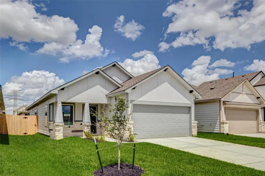 Brand-new single-story home with fresh curb appeal, a welcoming covered front porch, stone accents, and a two-car attached garage. The clean exterior, landscaped front yard, and bright sky create an inviting first impression for this new construction home in Glendale Lakes.