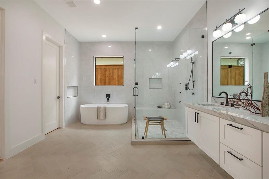 Bathroom featuring tile patterned floors, vanity, and separate shower and tub