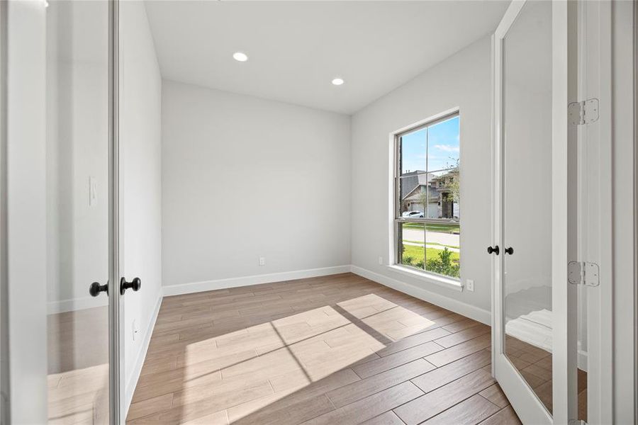 The home office is just off the foyer and features French doors for privacy.