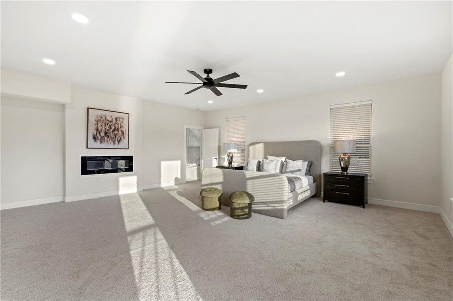 Bedroom with light carpet, recessed lighting, a glass covered fireplace, and a ceiling fan Bedroom with light carpet, recessed lighting, a glass covered fireplace, and a ceiling fan