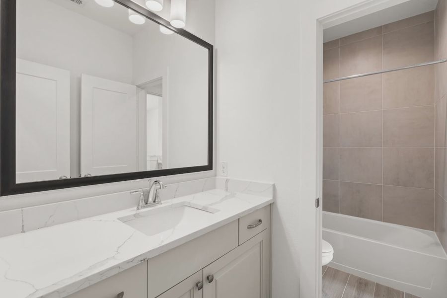 Representative furnished interior of a home built from the Macalister by Chesmar Homes in Artavia, Conroe (Image 9).