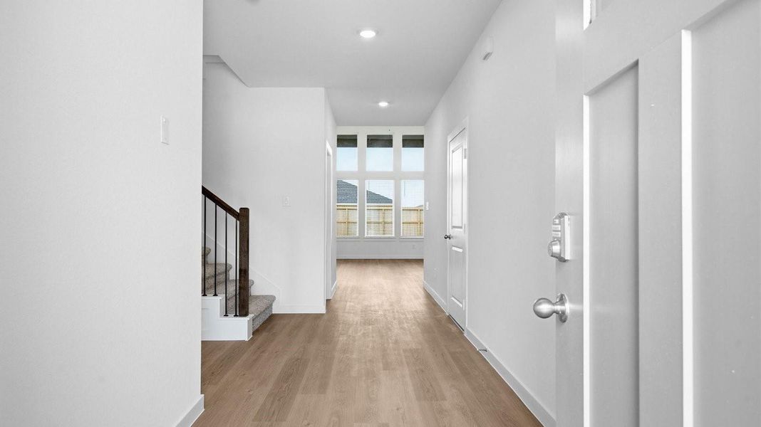 Entry hallway leading to living room and kitchen in the background.
