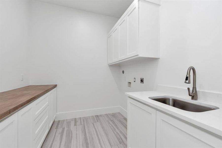 Streamlined Laundry Oasis: Featuring sleek cabinetry, ample counter space, and a practical utility sink.