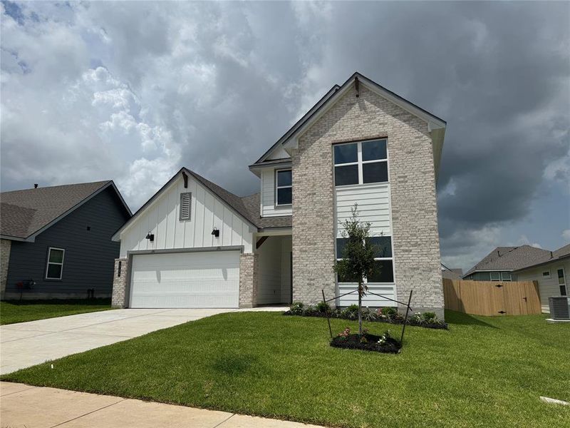 Front exterior of a new home in Liberty Village, Brenham, TX, highlighting curb appeal (Image 7).
