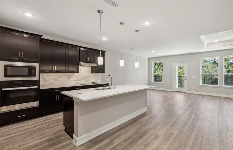 Airy kitchen with oversized island *real home pictured